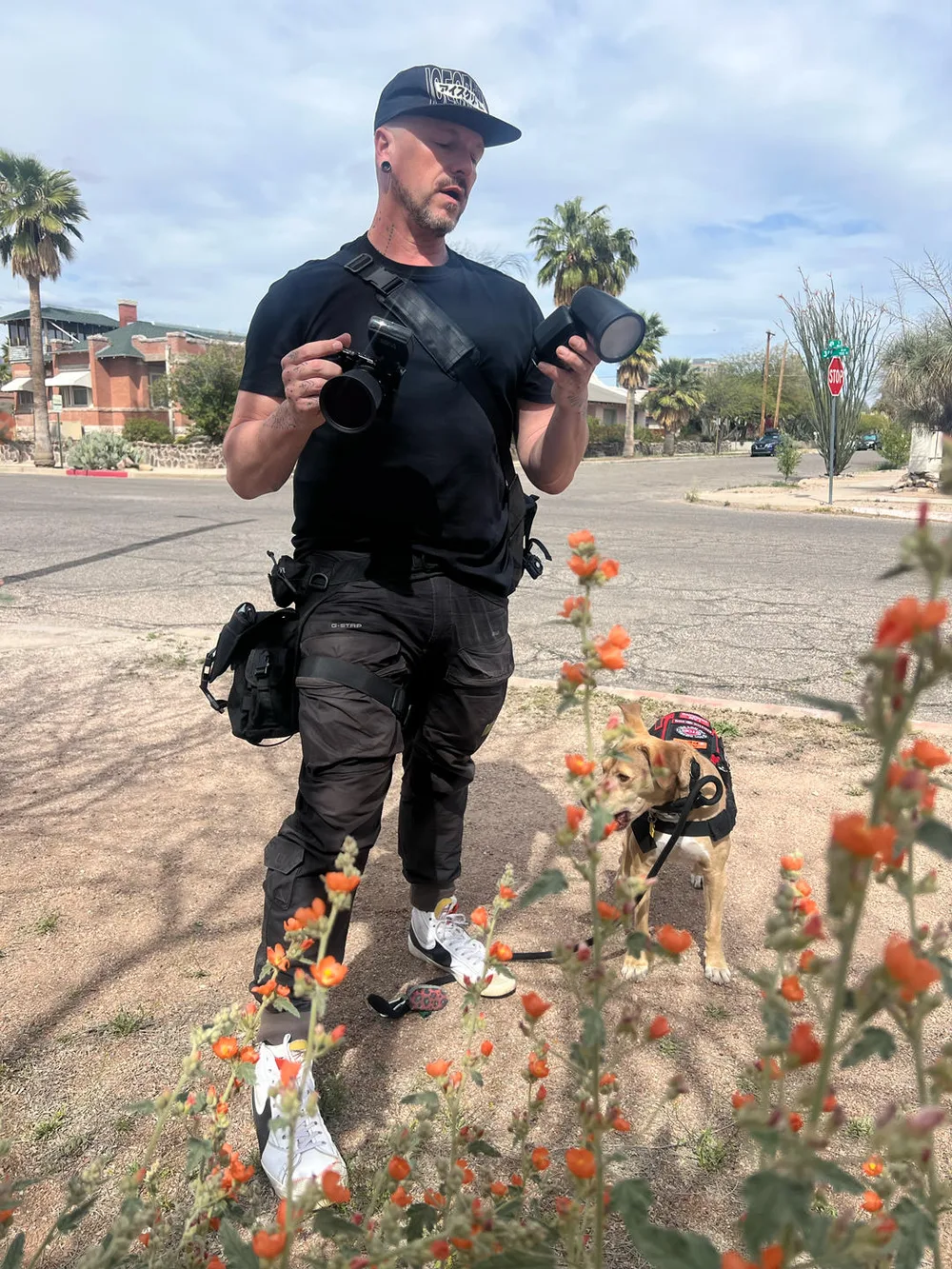 Wesley Parrish on location, camera in hand, service dog alongside